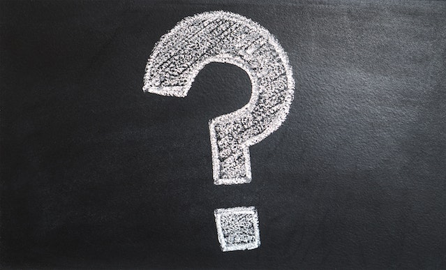 a question mark drawn in white chalk