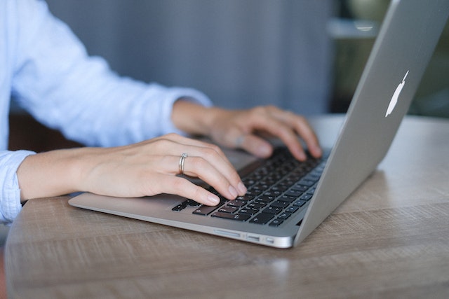 person typing a computer