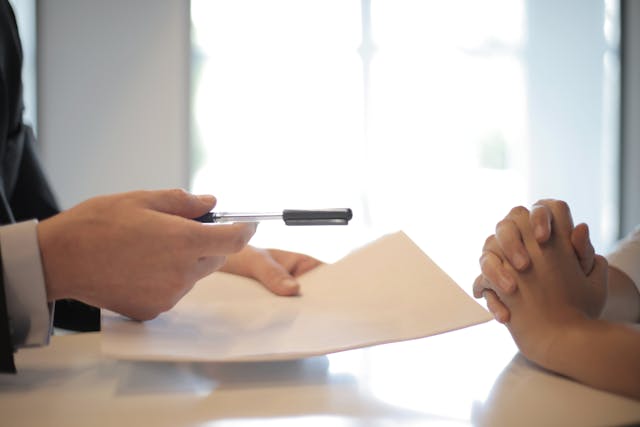 erson handing over documents to be signed